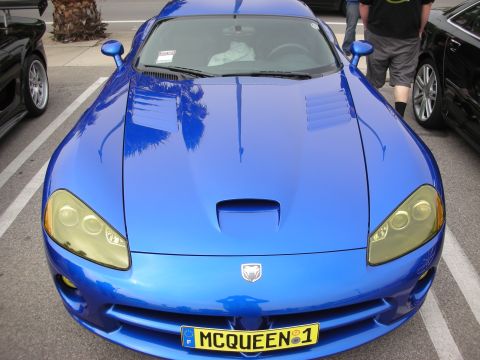 1998 Ford Crown Victoria - Overhead front angle of a blue Dodge Viper showing its long hood, headlights and yellow MCQUEEN 1 plate.