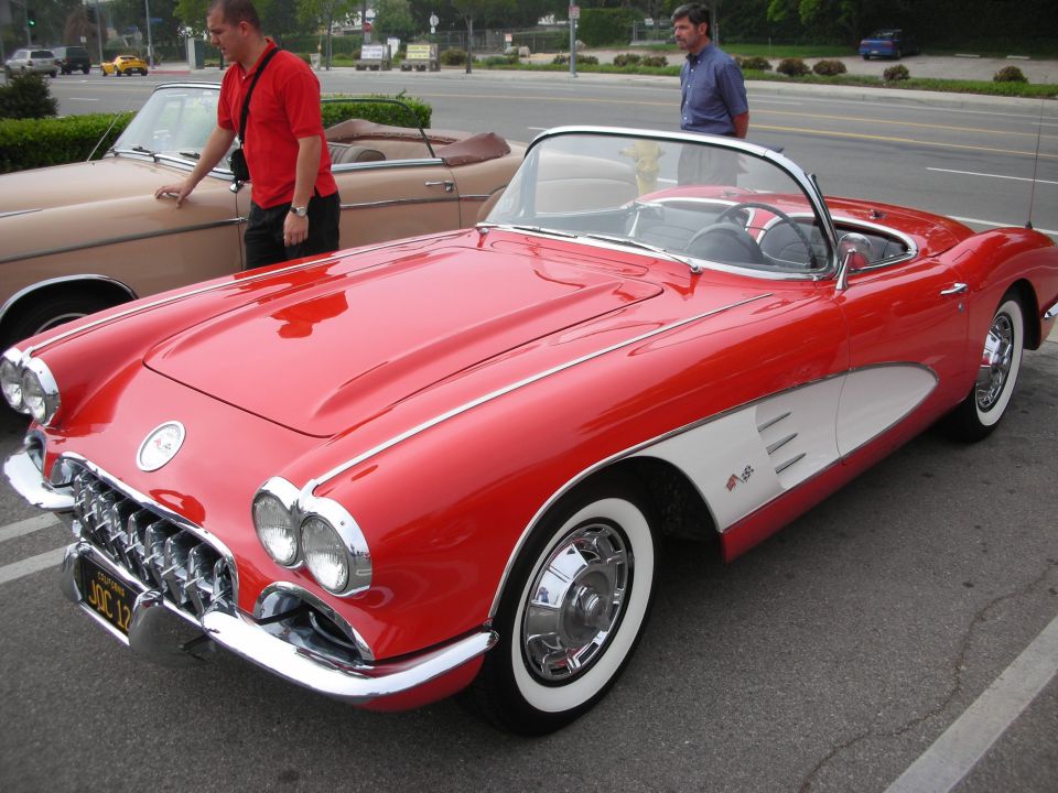 Red 1958 Chevrolet Corvette C1 roadster with wide whitewall tires