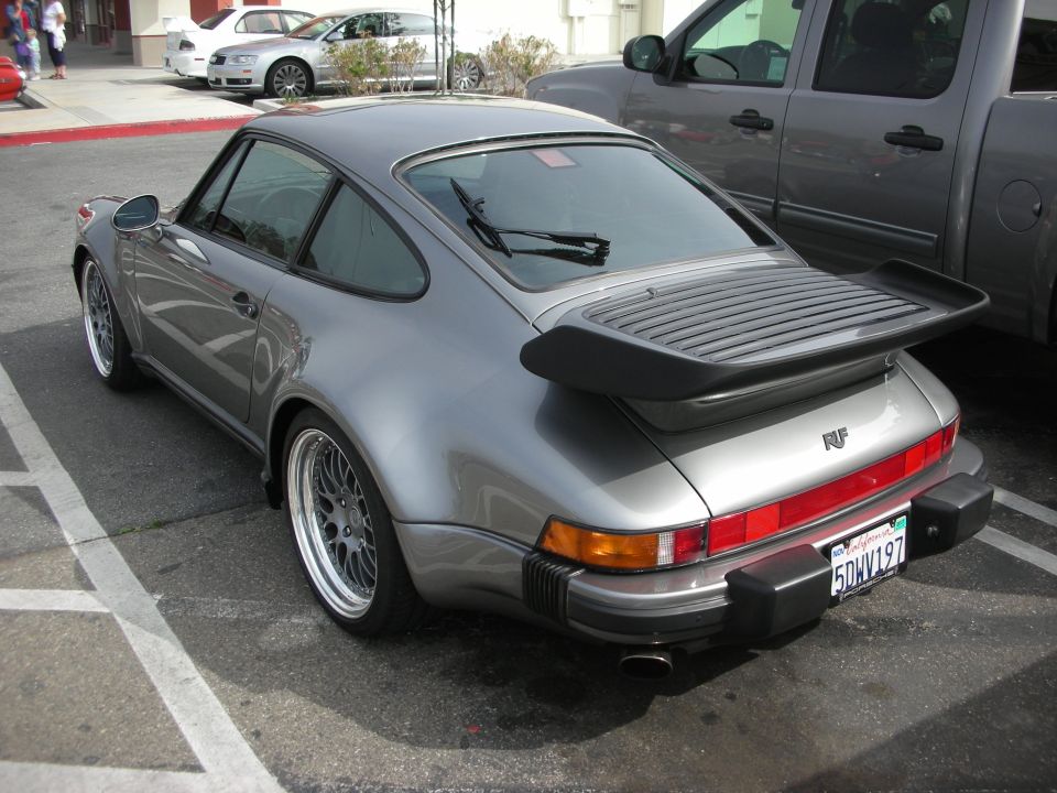 Grey Porsche 911 Turbo rear three-quarter with whale-tail spoiler and RUF badge
