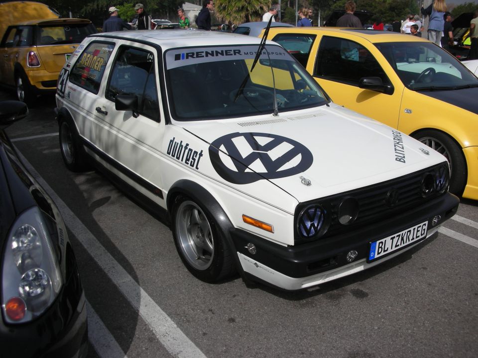White Volkswagen Golf Mk2 with VW logo and 'dubfest' graphics, plate BLTZKR1EG