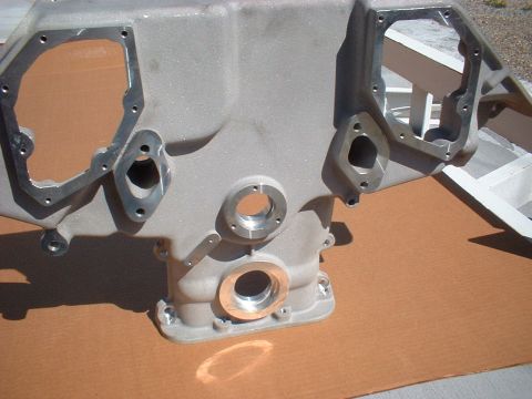 1964 Ford 427 - Close-up view of an aluminum engine block, likely a performance part, with various bolt holes and a copper insert visible.