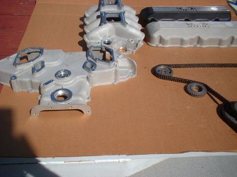 1964 Ford 427 - Engine components, including intake manifold and valve covers, laid out on a flat surface.