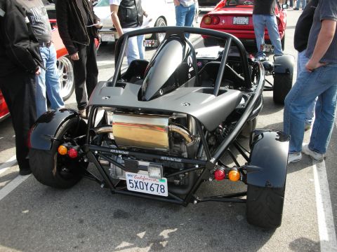 1998 Ford Crown Victoria - Rear view of a black tubular-frame Ariel Atom exoskeleton track car with exposed engine and California plate at a car show.