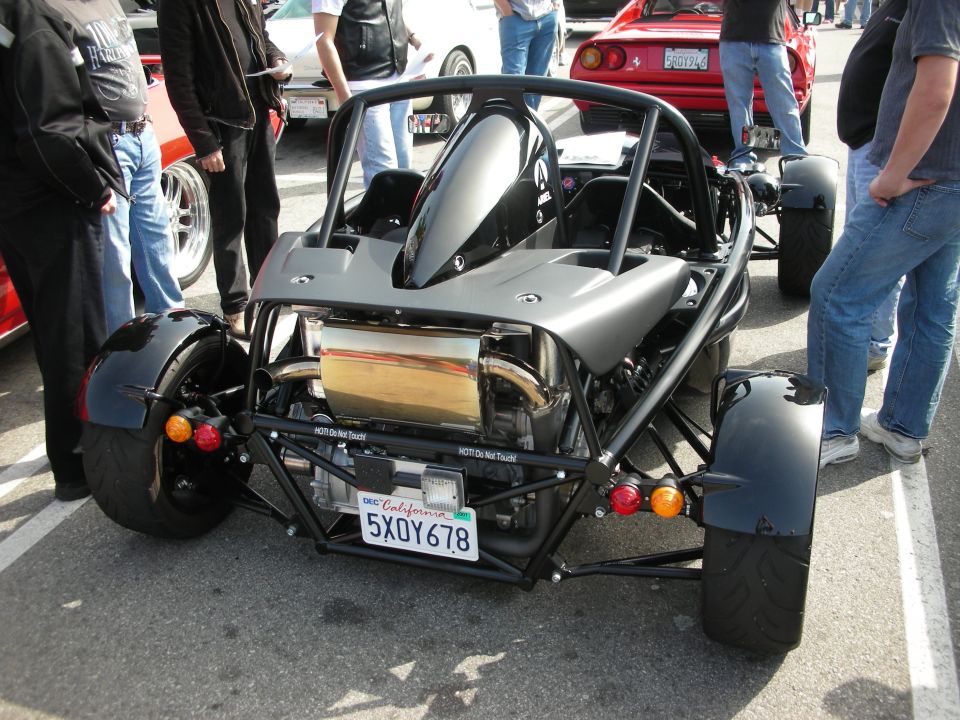 Rear of a black Ariel Atom exoskeleton track car at a show