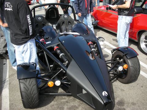 1998 Ford Crown Victoria - Front view of a black Ariel Atom exoskeleton track car showing its tubular frame and exposed pushrod suspension.