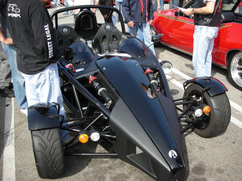 Front of black Ariel Atom exoskeleton car with exposed suspension