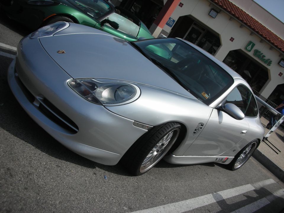 Front quarter view of silver Porsche 911 coupe in parking lot