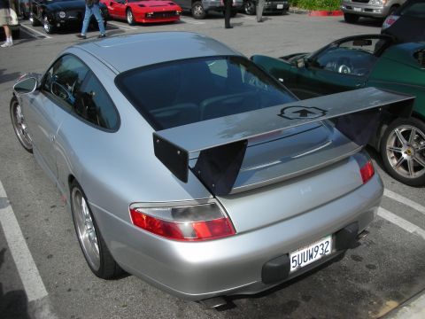 1998 Ford Crown Victoria - Rear three-quarter view of a silver Porsche 911 with a tall rear wing, license plate 5UUW932.