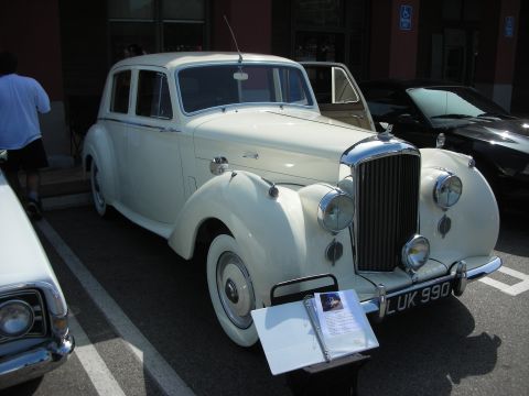 1998 Ford Crown Victoria - cream-colored vintage Bentley sedan with chrome grille and UK plate LUK 990 displayed at a show.