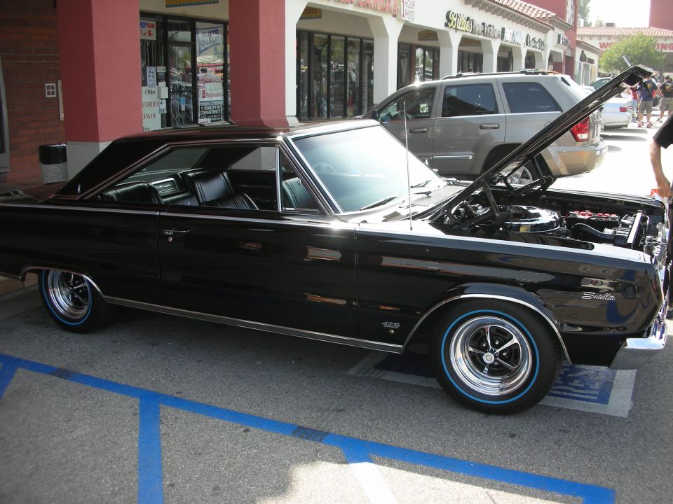 Black Plymouth Belvedere hardtop with blue-line tires, hood open