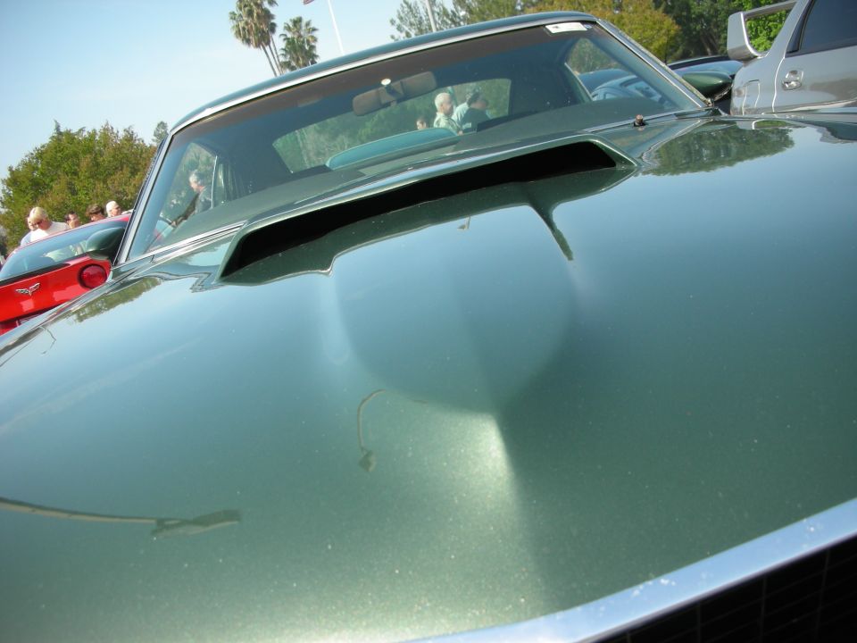 Close-up of green Mustang hood scoop and windshield