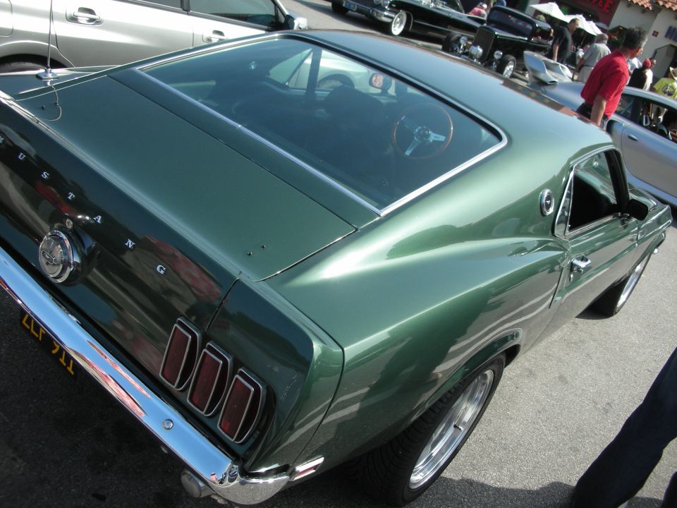 Rear quarter of green Ford Mustang fastback with MUSTANG lettering