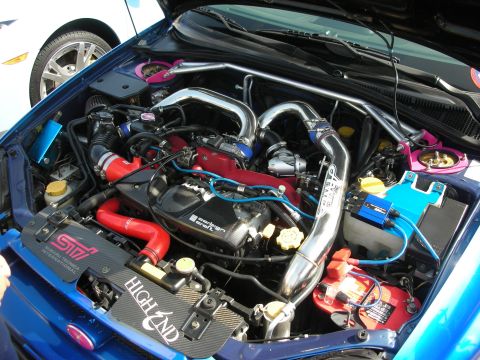 1998 Ford Crown Victoria - heavily modified Subaru boxer engine bay with polished intercooler piping, red silicone hoses and STi components.