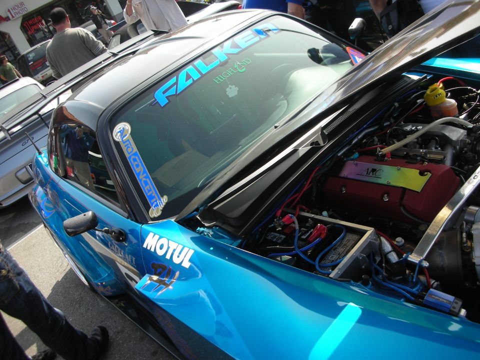 Teal Honda S2000 with open hood showing turbo engine and Falken decals