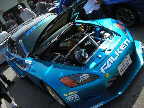 1998 Ford Crown Victoria - Front quarter of a teal Honda S2000 with hood open exposing its turbo setup and full Falken sponsor livery.