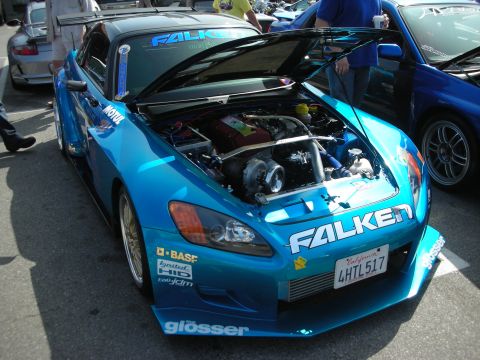 1998 Ford Crown Victoria - teal Honda S2000 photographed front-on with hood raised, showing a turbocharged engine and Falken graphics.