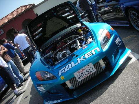 1998 Ford Crown Victoria - Angled front view of a teal Honda S2000 with hood open, front-mounted intercooler and bold FALKEN bumper decal.