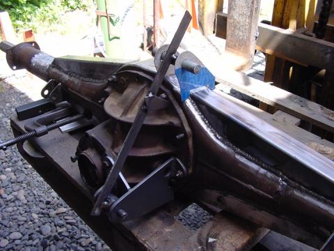 1979 Ford Bronco - Custom fabricated traction bar mounts welded onto a differential housing, with a blue protective plate attached.