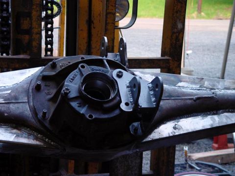 1979 Ford Bronco - A close-up view of a rear axle housing with custom traction bar mounts welded on.