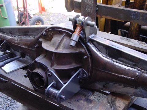 1979 Ford Bronco - Custom traction bar mounts are welded onto a rear axle assembly, suggesting modifications for performance or off-road use.