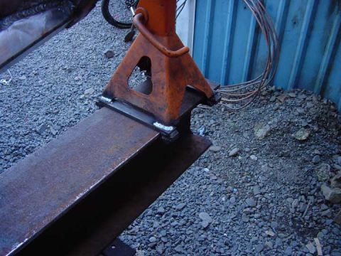 1979 Ford Bronco - Metal beams are being welded together, supported by an orange jack stand.