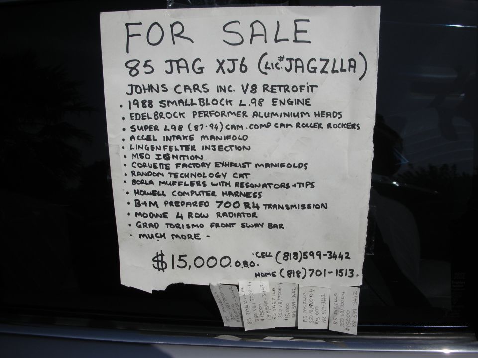 Handwritten FOR SALE sign for an 85 Jaguar XJ6 with V8 retrofit listing engine and drivetrain modifications