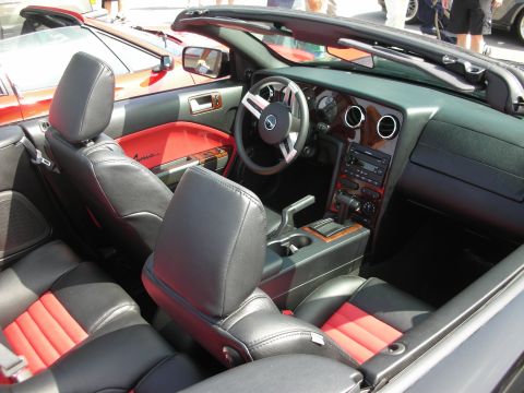 1998 Ford Crown Victoria - Convertible interior with black-and-red two-tone leather seats embroidered 'Avanti', wood-trim dash and a centered Ford steering wheel.