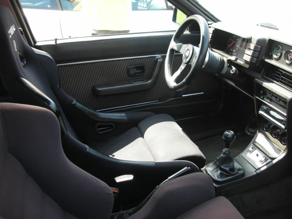 Sporty car interior with carbon-look door, bucket seat and manual shifter