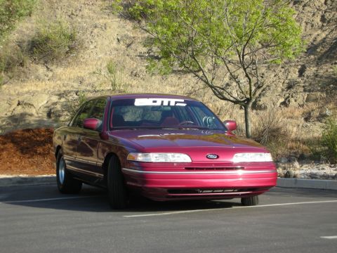 1992 Ford Crown Victoria - This maroon 1992 Ford Crown Victoria is parked outside on a sunny day.
