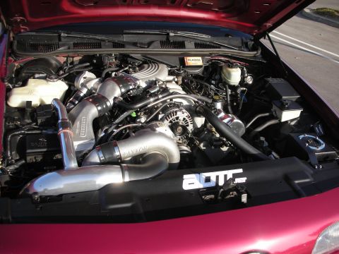 1992 Ford Crown Victoria - Engine bay of a red 1992 Ford Crown Victoria, modified with a Paxton supercharger and custom intercooler.
