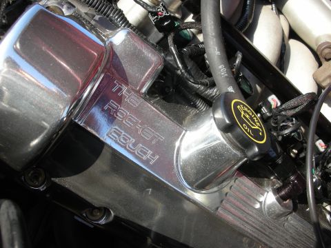 1992 Ford Crown Victoria - Close-up of engine components, including a custom engraved valve cover and an engine oil cap.