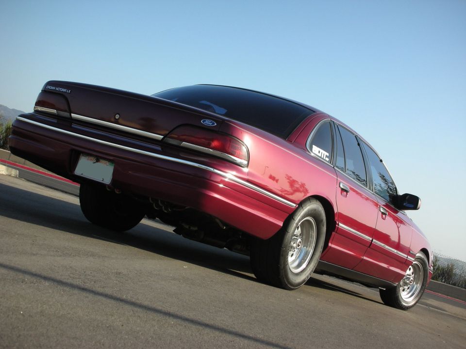Maroon 1992 Ford Crown Victoria with drag tires, rear 3/4 view