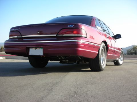 1992 Ford Crown Victoria - Rear view of a maroon 1992 Ford Crown Victoria LX with a lowered suspension and custom wheels.