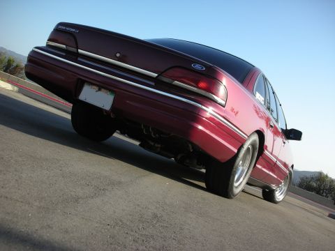1992 Ford Crown Victoria - Rear view of a maroon 1992 Ford Crown Victoria LX with a lowered stance and custom wheels.