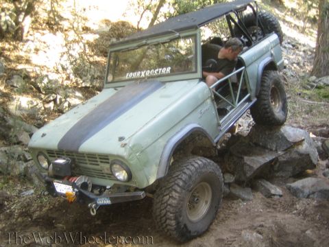 1987 Suzuki Samurai - This modified Ford Bronco navigates a rocky trail, demonstrating its off-road capabilities.