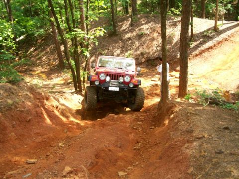 1993 Ford Bronco - Billy's Rubi Red right tire in the air on Fun-Country