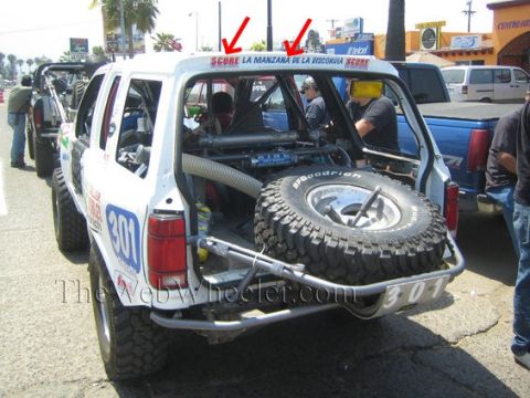 1992 Ford Explorer - Modified 1992 Ford Explorer race vehicle with spare tire mounted at the rear and racing decals visible.