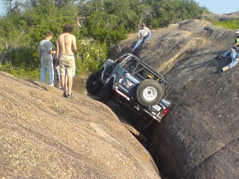 1986 Ford Bronco - This 1986 Ford Bronco navigates a challenging rocky terrain, its off-road capabilities.