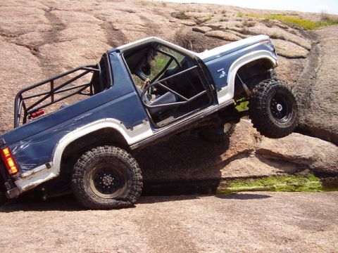 1986 Ford Bronco - Modified 1986 Ford Bronco navigating difficult rocky terrain.