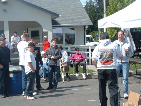 2000 Ford Crown Victoria - An outdoor gathering of people with a white van in the background.