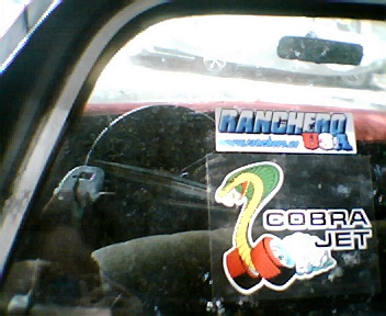 1973 Ford Ranchero - Interior view showing 'Ranchero USA' and 'Cobra Jet' stickers on the rear window.