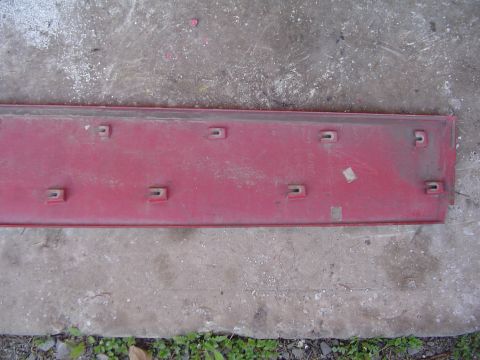 1994 Ford Probe - A red trim piece, likely for a car's exterior, is shown with its underside numerous U-shaped clips for attachment.