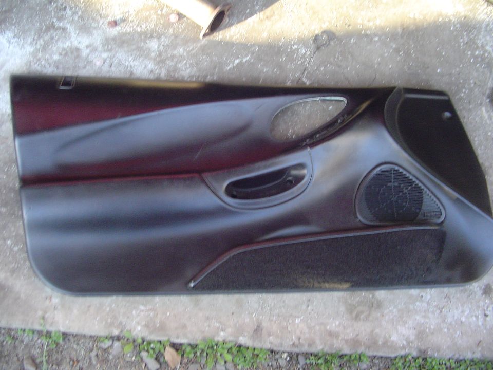 Black car door panel with speaker grille