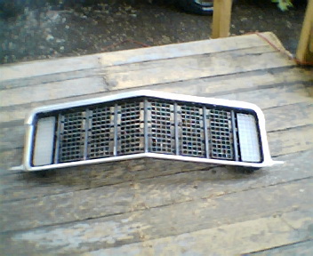 1973 Ford Ranchero - This is a grille assembly for a 1973 Ford Ranchero, a V-shaped design with vertical and horizontal bars.