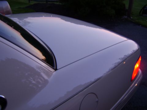 1996 Mercury Grand Marquis - Rear view of a white sedan, showing the trunk and a lit taillight, with body style indicating a 1995 model year.