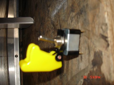 1979 Ford Bronco - A yellow toggle switch with a metal lever is mounted on a wooden surface. Text from Supermotors.net is visible at the bottom right.