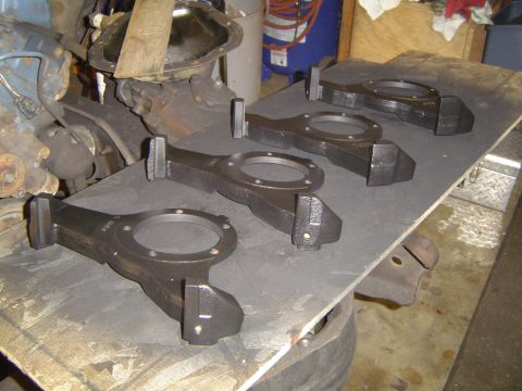 1978 Ford Bronco - Four engine connecting rods are visible on a workbench, with other engine components in the background.