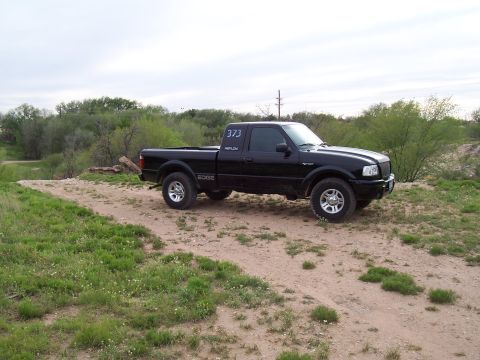2003 Ford Ranger - Black 2003 Ford Ranger Edge pickup truck parked on a dirt road.