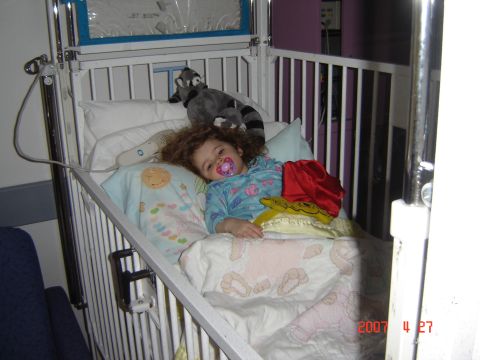 1993 Ford Bronco - A child rests in a hospital bed with a pacifier and stuffed animals nearby.