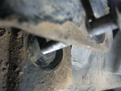2001 Jeep Wrangler - A close-up view of a bolt and its mounting bracket, showing mechanical components.